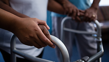 Detainees using walkers in a care or detention setting.